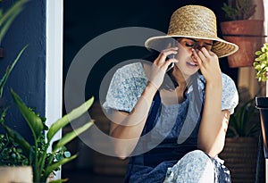 The truth is that stress doesnt come from your boss. a young florist looking stressed while on a call at work.