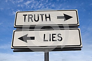 Truth vs lies. White two street signs with arrow on metal pole with word