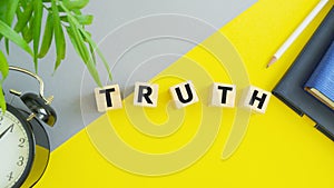 Truth word on wooden cubes on yellow background. Business concept. Square wood blocks. Top view, flat lay