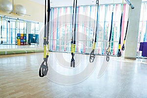 Trx fitness straps for working with own weight, Trx fitness belts hanging in the gym