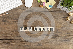 Try Again, Wooden cube with a Try Again message placed on an old wooden desktop