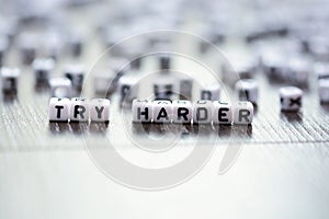 Try harder inspirational advice spelled by tiled letter beads