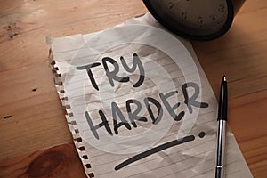 Try Harder, text words typography written on paper, success  life and business motivational inspirational