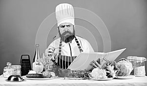 Try something new. Cookery on my mind. Cooking skill. Book recipes. According to recipe. Man bearded chef cooking food