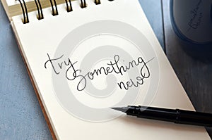 TRY SOMETHING NEW hand-lettered in notepad photo