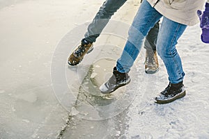 Trying the danger of the foot, testing the thin ice near the shore. A pair of lovers walk with a walk along a frozen lake to press