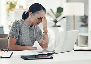 Trying hard to regain her focus. a young businesswoman looking stressed out while working in an office.