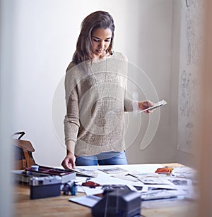 Trying to select the right series of images. A young woman working on her portfolio at home.