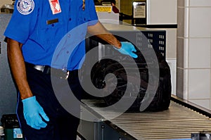 TSA handling a bag