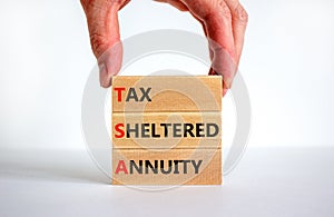 TSA, tax sheltered annuary symbol. Concept words TSA, tax sheltered annuary on wooden blocks. Beautiful white background,