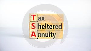 TSA, tax sheltered annuary symbol. Concept words TSA, tax sheltered annuary on wooden blocks. Beautiful white background, copy