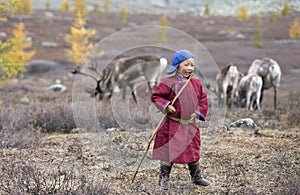 Tsaatan boy, dressed in a traditional deel playing outside