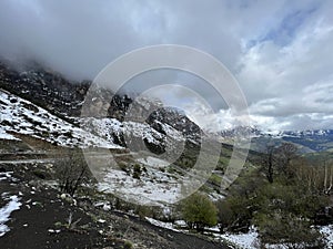 Tseylomsky pass in Ingushetia. A trip uphill to the Tsei Loam pass on a cloudy spring day. Panorama of the high cliffs