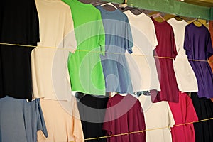 Tshirts hang in local shop or market in castries, st.lucia. Colorful clothes on sale. Sale, shopping and purchase. Black