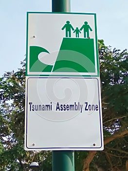 Tsunami Assembly zone sign on  blue sky background