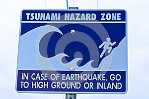 A tsunami hazard zone sign warning along the coast