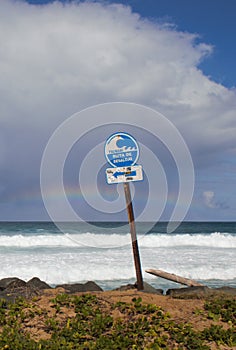 A tsunami sign at a beach on a cloudy day at Puerto Rico.