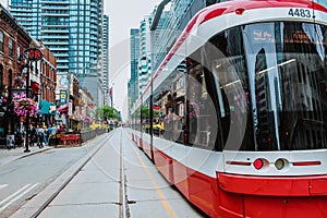 TTC Close view os a streetcar in downtown Toronto's entertainment district. New tram on streets of Toronto. TORONTO, ONTARIO