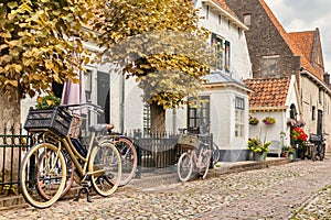 Ttiny old houses with bicycles in the Dutch hanseatic city of Elburg, The Netherlands