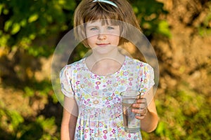 Little girl kid with glass of water in morning, drink every day