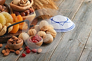 Tu Bishvat celebration concept. Mix of dry fruits and nuts almonds, hazelnuts, walnuts, apricots, prunes, cherries, raisins, dates