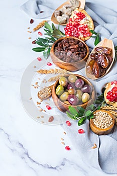 Tu Bishvat holiday symbols - dried fruits, pomegranate, barley, wheat