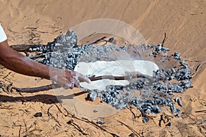 Tuareg man preparing the traditional bread photo