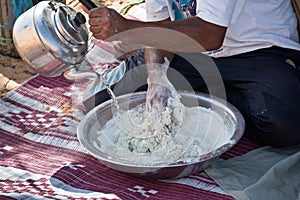 Tuareg man preparing the traditional bread photo