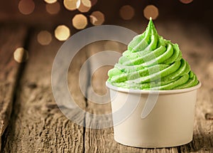 Tub of twirling creamy green Italian ice cream