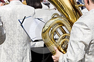 Tuba player at brass band during open air concert