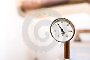 Tube pressure gauge measuring the water temperature on central home heating system