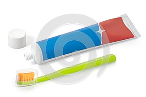 A tube of red and blue toothpaste and a toothbrush on a white background. Full depth of field.