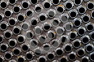 Tube sheet of the heat exchanger for new fabrication, the water heater in the boiler as background