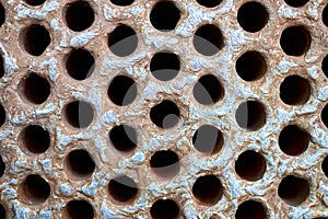 Tube sheet plate of heat exchanger or boiler closeup texture macro industrial background with insoluble hard mineral