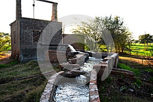 Tube well and temporary water reservoir in a small village of Pakistan