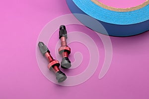 tubeless presta valves with tube less rim tape on plain background (cut out, isolated on magenta) valve