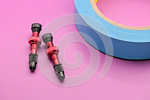 tubeless presta valves with tube less rim tape on plain background (cut out, isolated on magenta) valve