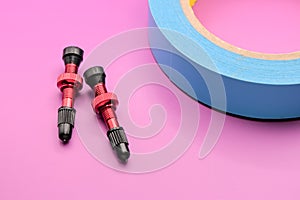 tubeless presta valves with tube less rim tape on plain background (cut out, isolated on magenta) valve