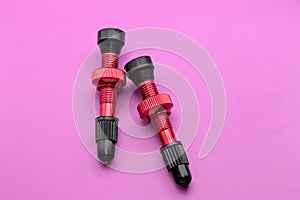 tubeless presta valves with tube less rim tape on plain background (cut out, isolated on magenta) valve