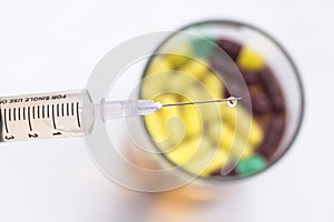 Tuberculin Syringe and Sterile Vial Filled with Medication Solution made up from capsules.