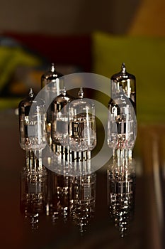 Tubes for electric guitar amplifier ECC83 - 12AX7 and EL84 types. Vacuum electron tubes closeup with glass reflections.