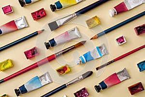 Tubes of paint with pencil crayons in diagonal lines