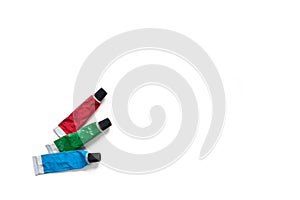 Tubes with red, green, blue acrylic paints isolated on white background. RGB colors. Creativity and hobby concept