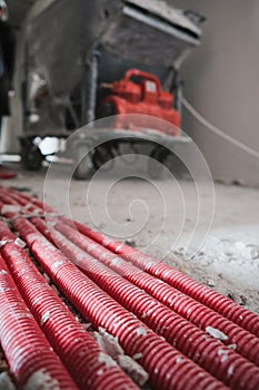 Tubing. Red plumbing pipe at interior of construction site