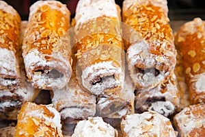 Tubules from puff pastry strewed with grated almonds