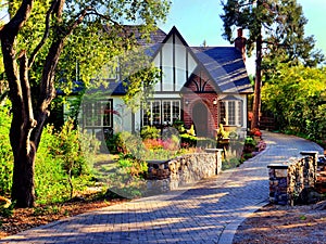 Tudor style luxury villa with a small stone bridge leading to the entrance