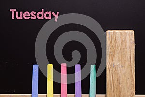 Tuesday on Blackboard with chalk and eraser