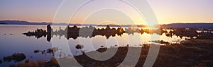 Tufa rock formations emerging from Mono Lake at sunrise, California