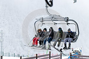 Tufandag, Gabala - Azerbaijan: 30 January 2021. Happy friends on ski lift chair enjoying winter ski vacations in
