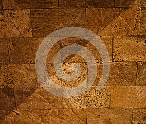 A tuff wall with a shadow falling on it.